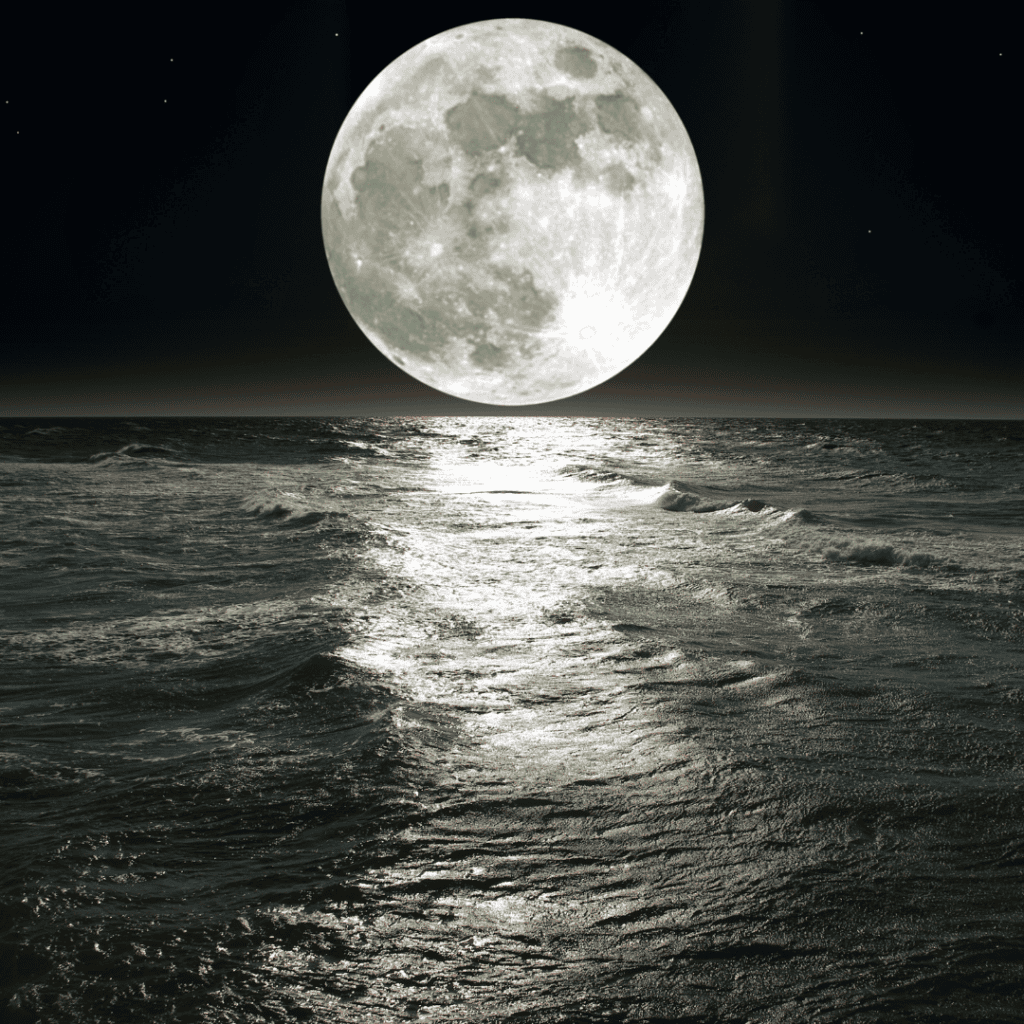 A glowing moon over the water